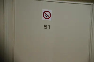a door with a no smoking sign on it at Aparthotel Tycho de Brahe in Prague