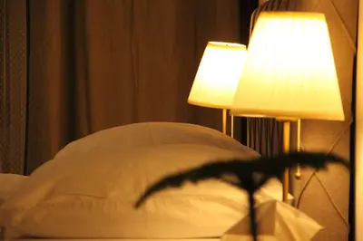a bedroom with a bed with two lamps on it at Aparthotel Tycho de Brahe in Prague
