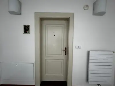a white door in a room with a white wall at Aparthotel Tycho de Brahe in Prague