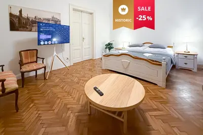 a bedroom with a bed and a table and a tv at Goldy River 3 BDR & 1 BTH Residence XXL 120m2 in Prague