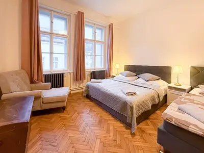 a bedroom with a bed and a chair at Goldy River 3 BDR & 1 BTH Residence XXL 120m2 in Prague