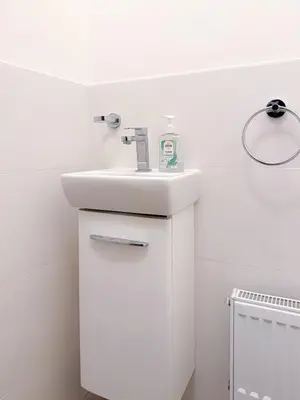 a bathroom with a white sink and a white cabinet at Goldy River 3 BDR & 1 BTH Residence XXL 120m2 in Prague