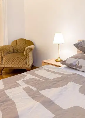 a bedroom with a bed and a chair and a lamp at Goldy River 3 BDR & 1 BTH Residence XXL 120m2 in Prague