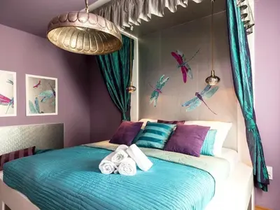 a bedroom with a bed with towels on it at Purple Dragon 3BDR apartment in Prague