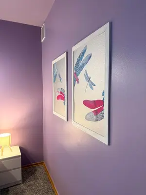 a room with three pictures on a purple wall at Purple Dragon 3BDR apartment in Prague
