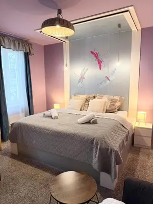 a bedroom with a large bed with a large mirror at Purple Dragon 3BDR apartment in Prague