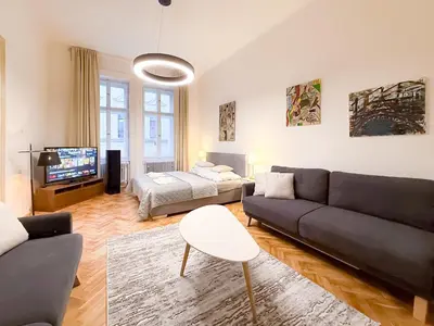 a living room with a couch and a bed at Picasso Residence XXL 100m2 in Prague