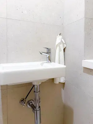 a white sink in a bathroom with a towel at Picasso Residence XXL 100m2 in Prague