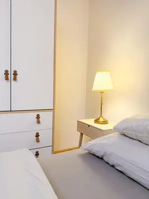 a bedroom with a bed and a lamp on a dresser at Picasso Residence XXL 100m2 in Prague