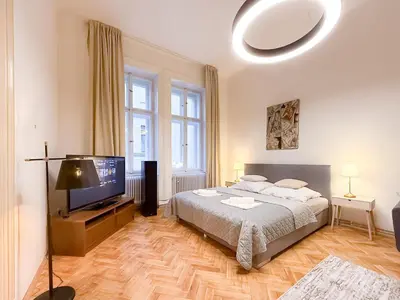 a bedroom with a bed and a flat screen tv at Picasso Residence XXL 100m2 in Prague