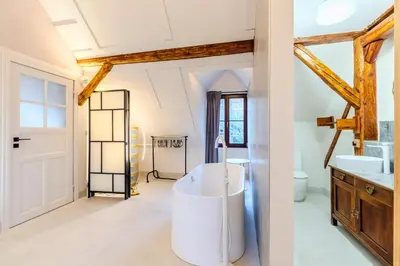 a bathroom with a tub in the middle of a room at Jevany Four Bedroom Luxury Villa by the Lake with Infrasauna and Grill in Jevany