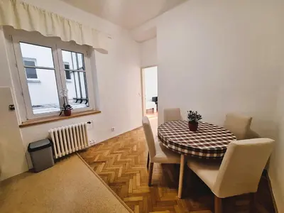 a dining room with a table and chairs and a window at St. Hubert House in Prague