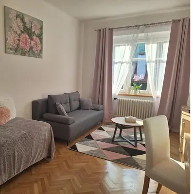 a living room with a couch and a chair at St. Hubert House in Prague