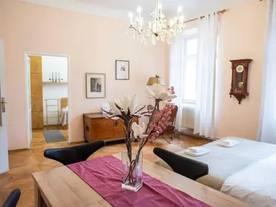 a dining room with a table with flowers in a vase at Golden Horse in Prague