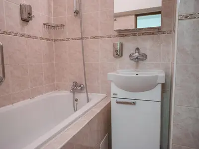 a bathroom with a sink and a bath tub and a sink at Golden Horse in Prague