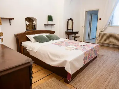 a bedroom with a large bed and a table at Golden Horse in Prague