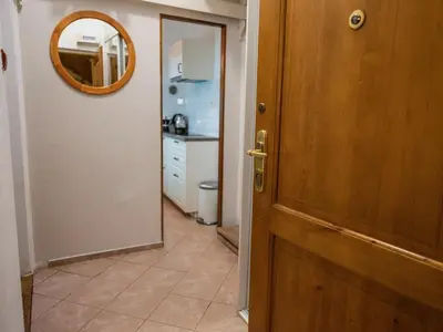 a door leading into a kitchen with a mirror at Golden Horse in Prague