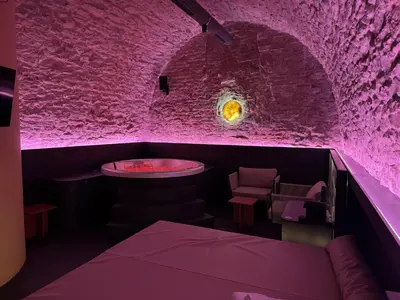 a purple room with a table and chairs at SPA SPA Petrská in Prague