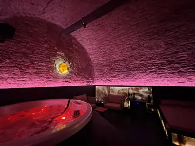 a bathroom with a red bath tub and a sink at SPA SPA Petrská in Prague