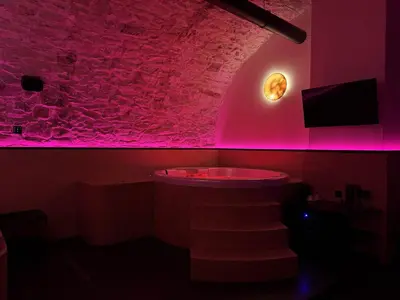 a red room with a bath tub and a rock wall at SPA SPA Petrská in Prague