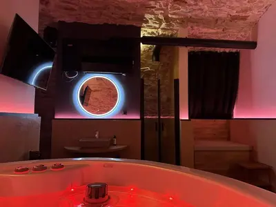 a bathroom with a bath tub with a round window at SPA SPA Petrská in Prague