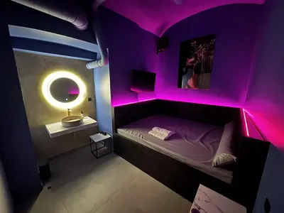 a room with a purple room with a bed and a sink at SPA SPA Petrská hostel in Prague