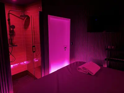 a bathroom with a pink door and a shower at SPA SPA Petrská hostel in Prague