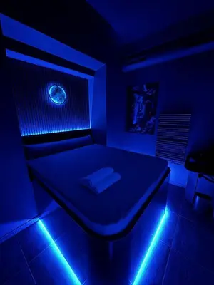 a room with a bed with a blue light at SPA SPA Petrská hostel in Prague