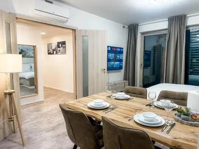 a dining room with a table and chairs and a bed at Modern AC Apt | Free Parking | 15 Min Center in Prague