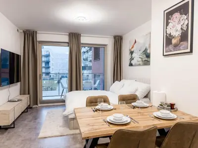 a room with a dining table and a bed at Modern AC Apt | Free Parking | 15 Min Center in Prague