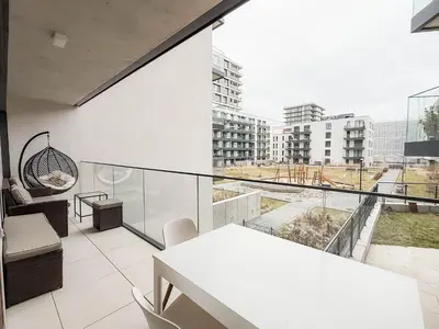 an apartment with a balcony with a view of a city at Modern AC Apt | Free Parking | 15 Min Center in Prague
