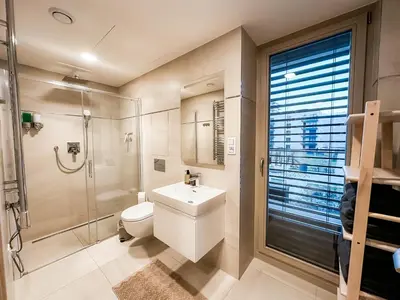 a bathroom with a toilet and a shower and a sink at Modern AC Apt | Free Parking | 15 Min Center in Prague