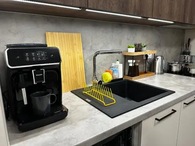 a kitchen counter with a sink and a microwave at Modern AC Apt | Free Parking | 15 Min Center in Prague
