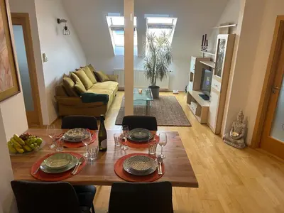 a living room with a table and a couch at Prague For You 22 in Prague