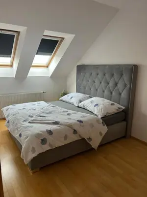 a white kitchen with white cabinets and a counter at Prague For You 22 in Prague