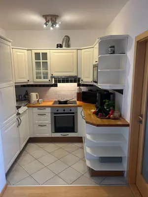 a kitchen with white cabinets and a stove top oven at Prague For You 22 in Prague