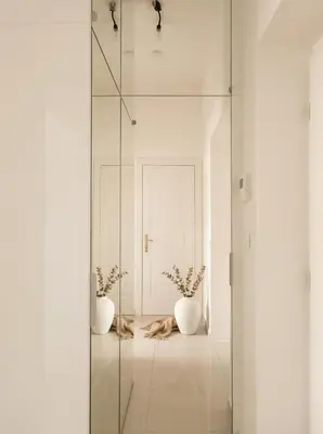 a glass shower door with two vases on the floor at Emora Terrace Apartment in Prague