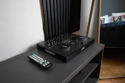 a stove with two remote controls sitting on a table at Twin Residence Retro-Cinematic Apartment in City Centre in Prague
