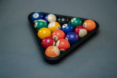 a tray of billiard balls sitting on a table at Twin Residence Retro-Cinematic Apartment in City Centre in Prague