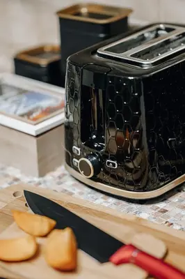 a toaster sitting on a counter next to a cutting board at Twin Residence Retro-Cinematic Apartment in City Centre in Prague