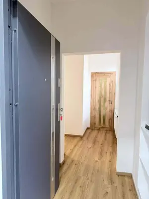an empty room with a door and a wooden floor at Parkány Litoměřice in Litoměřice