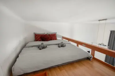 a bed with two stuffed animals on it in a room at Downtown Comfort in a Spacious Apartment in Prague
