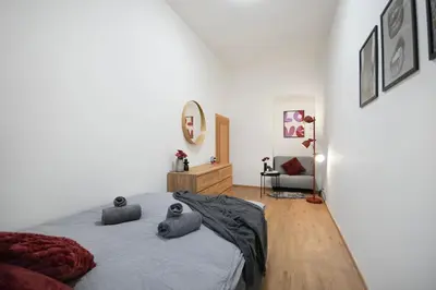 a bedroom with a bed with two pillows on it at Downtown Comfort in a Spacious Apartment in Prague