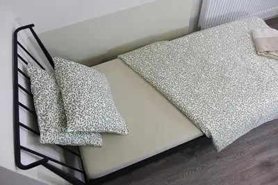 a bed with two pillows on top of it at Chalupa Kdovíkde in Budyně nad Ohří