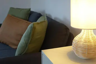 a lamp sitting on a table next to a couch at Chalupa Kdovíkde in Budyně nad Ohří