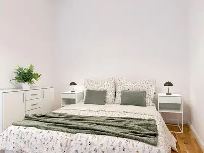 a white bedroom with a large bed and two night stands at REAL Living by REFA - New Town 216 in Prague