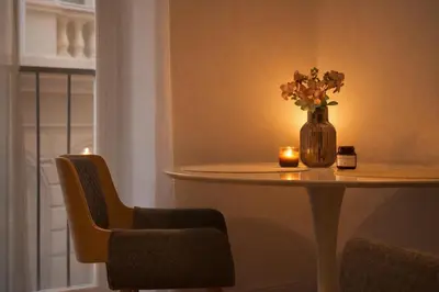 a vase of flowers sitting on a table with a candle at REAL Living by REFA - New Town 216 in Prague