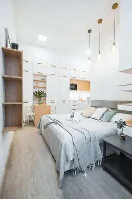 a white bedroom with a large bed and a desk at Central Studio Apartment with Parking - Near Main Train Station & Wenceslas Square in Prague