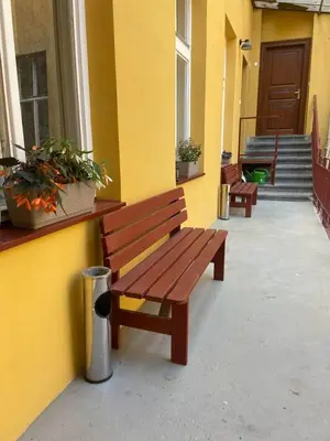 two benches sitting on the side of a building at Central Studio Apartment with Parking - Near Main Train Station & Wenceslas Square in Prague