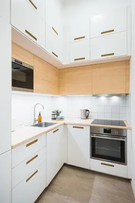 a kitchen with white cabinets and a sink at Central Studio Apartment with Parking - Near Main Train Station & Wenceslas Square in Prague
